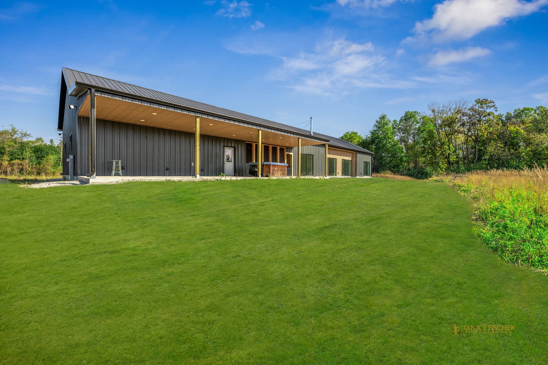 Rear elevation of the Bella model barndominium with a covered outdoor area