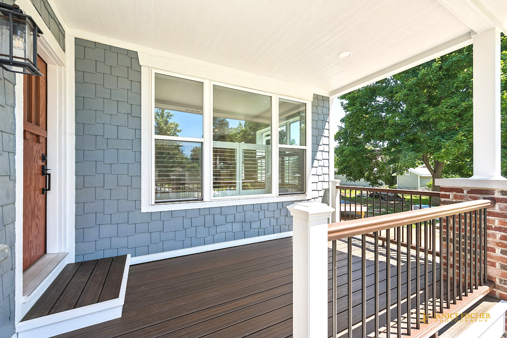 Lake Geneva home remodel with blue shake siding, white-framed windows, composite deck, and railing