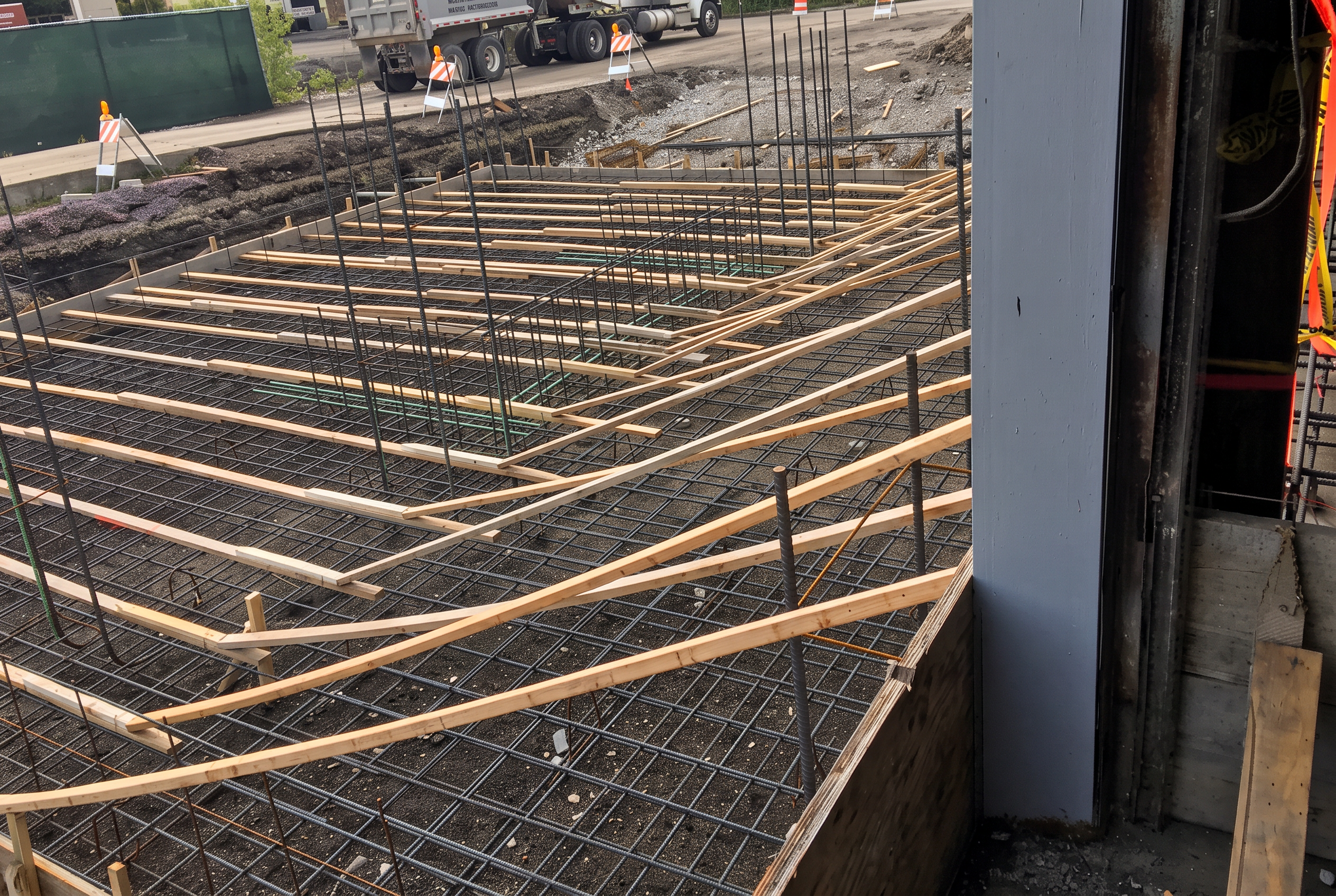 Reinforcing steel mat and screed boards set over a formed concrete deck before the pour